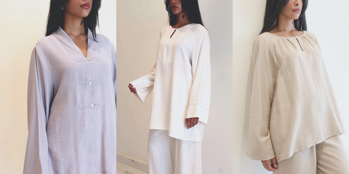 Trois tenues en lilas, ecru et beige devant un mur creme uni